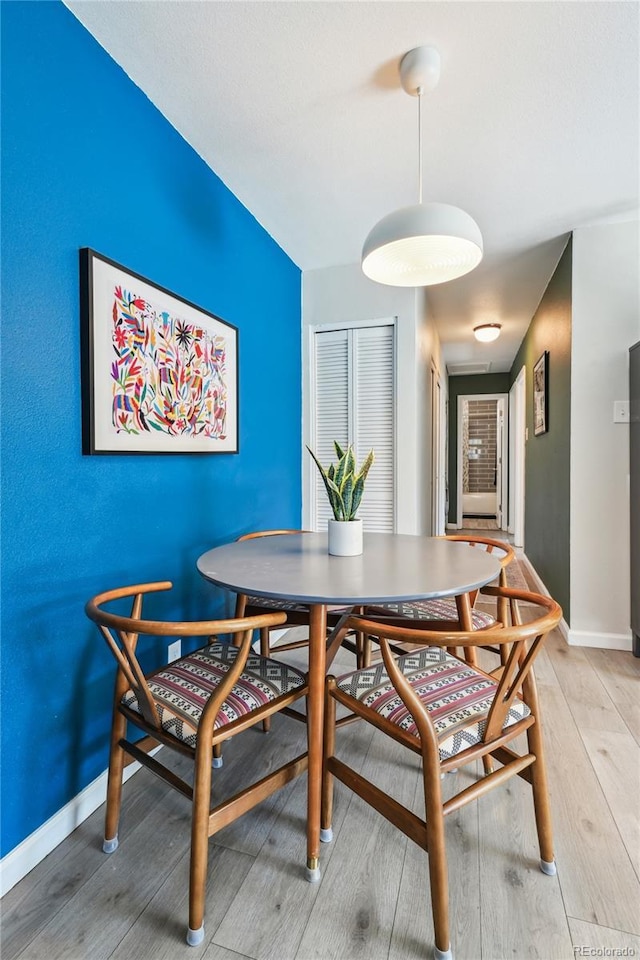 1225 S Oneida St Unit 248, Denver, CO 80224 - dining room with light wood finished floors and baseboards