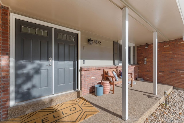 view of exterior entry with a porch