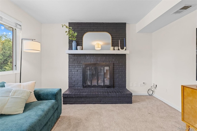 living room featuring a fireplace, light colored carpet, and plenty of natural light