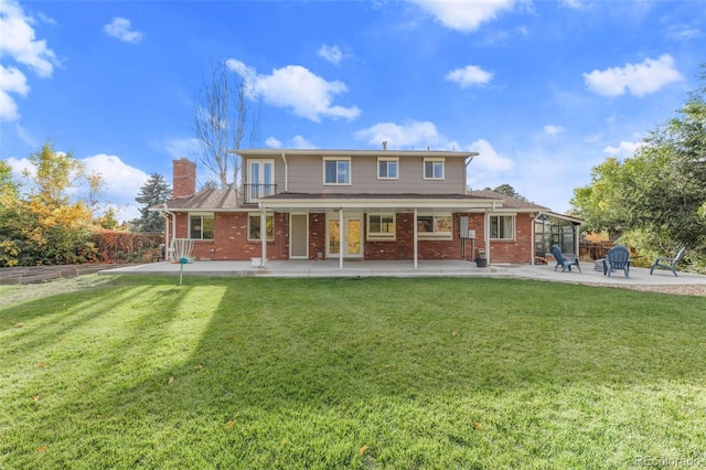 back of house with a yard and a patio area