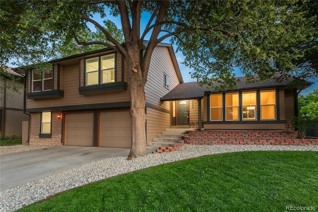 773 S Dearborn Cir, Aurora, CO 80012 - view of front of house with an attached garage, concrete driveway, a front lawn, stone siding, and roof with shingles
