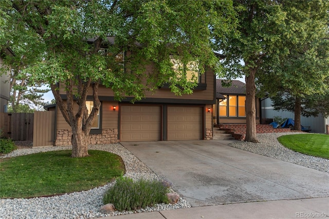 773 S Dearborn Cir, Aurora, CO 80012 - view of front facade with a garage, driveway, and stone siding