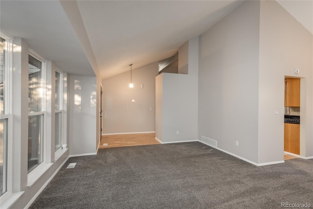 773 S Dearborn Cir, Aurora, CO 80012 - empty room featuring dark colored carpet and high vaulted ceiling