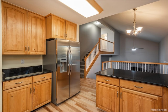 773 S Dearborn Cir, Aurora, CO 80012 - kitchen featuring stainless steel fridge, light wood-type flooring, dark countertops, a chandelier, and hanging light fixtures