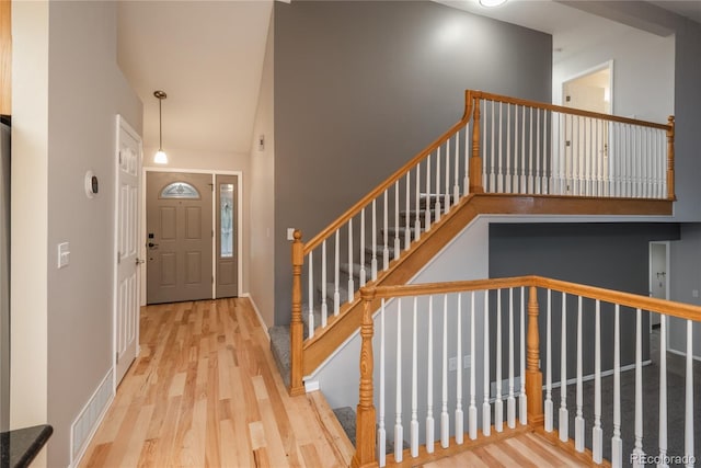 773 S Dearborn Cir, Aurora, CO 80012 - entryway featuring wood finished floors, a high ceiling, and stairs