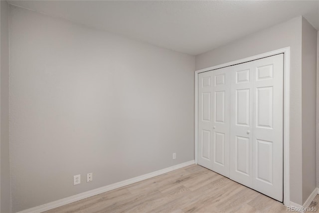 773 S Dearborn Cir, Aurora, CO 80012 - unfurnished bedroom featuring light wood-type flooring and a closet
