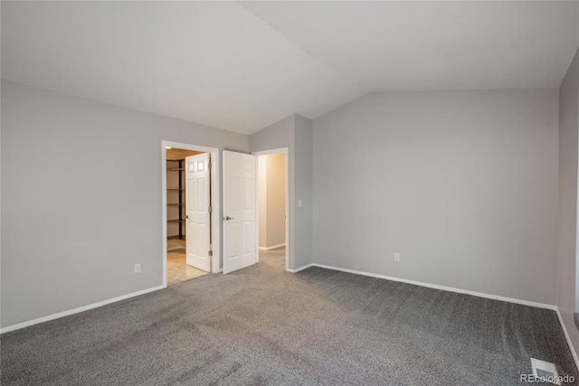 773 S Dearborn Cir, Aurora, CO 80012 - unfurnished bedroom with carpet flooring, vaulted ceiling, and ensuite bath