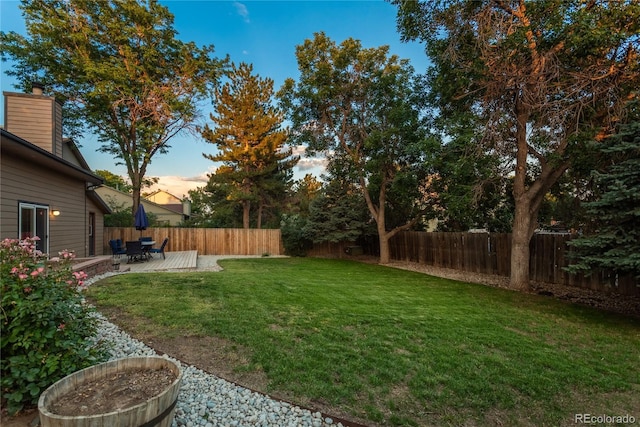 773 S Dearborn Cir, Aurora, CO 80012 - yard at dusk with a fenced backyard and a patio area