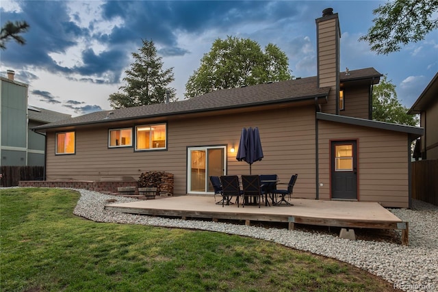 773 S Dearborn Cir, Aurora, CO 80012 - rear view of property with a wooden deck, a chimney, and outdoor dining area