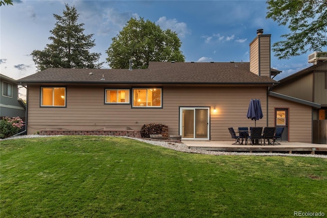 773 S Dearborn Cir, Aurora, CO 80012 - rear view of property featuring a yard, a chimney, and a shingled roof