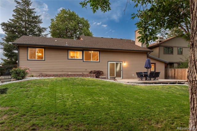 773 S Dearborn Cir, Aurora, CO 80012 - back of house with a patio, a chimney, and a shingled roof