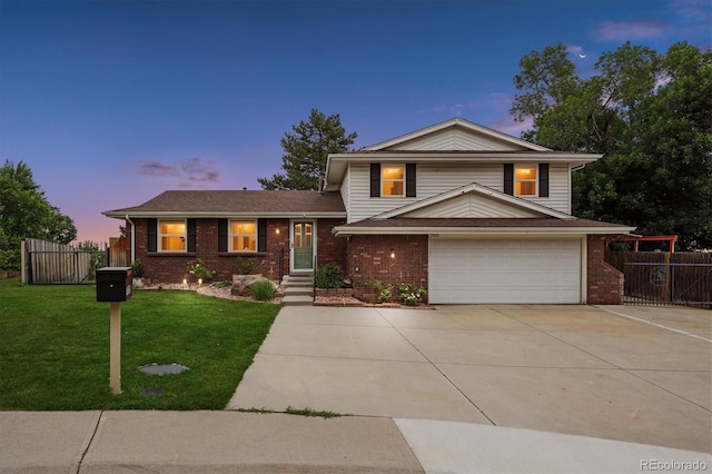 7323 Upham Ct, Arvada, CO 80003 - tri-level home featuring an attached garage, concrete driveway, and brick siding