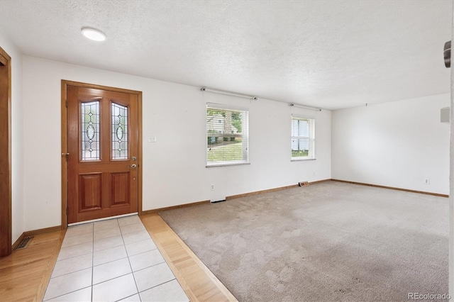 7323 Upham Ct, Arvada, CO 80003 - foyer featuring a textured ceiling and light wood finished floors