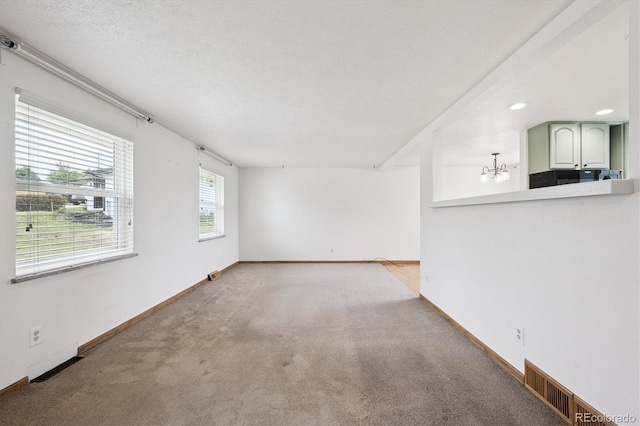 7323 Upham Ct, Arvada, CO 80003 - unfurnished living room featuring carpet, a chandelier, and recessed lighting