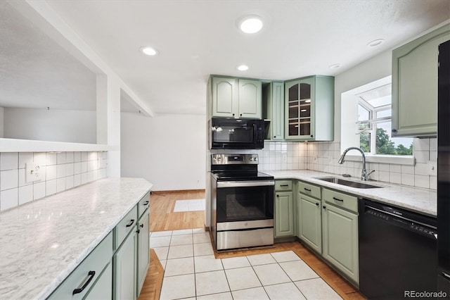 7323 Upham Ct, Arvada, CO 80003 - kitchen featuring black appliances, green cabinets, backsplash, and recessed lighting