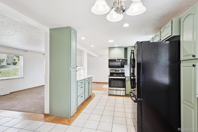 7323 Upham Ct, Arvada, CO 80003 - kitchen featuring black appliances, green cabinets, a chandelier, light countertops, and light tile patterned floors