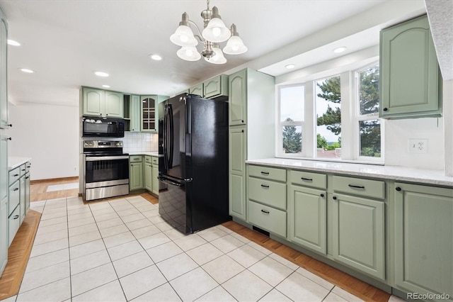 7323 Upham Ct, Arvada, CO 80003 - kitchen with black appliances, green cabinets, decorative backsplash, light tile patterned floors, and recessed lighting