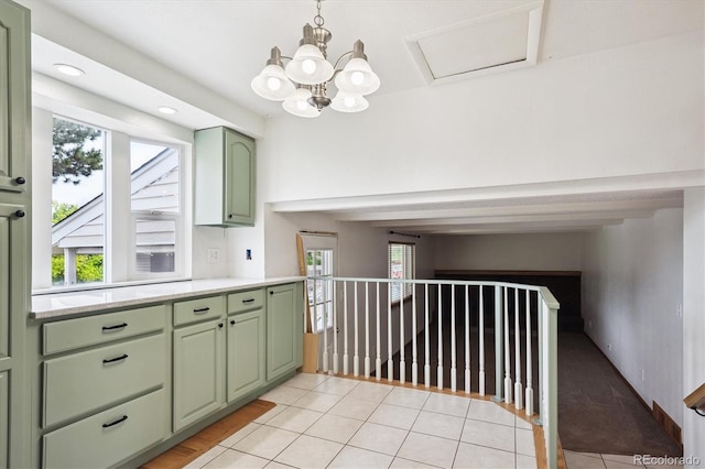 7323 Upham Ct, Arvada, CO 80003 - kitchen featuring green cabinetry, light countertops, light tile patterned flooring, and a chandelier