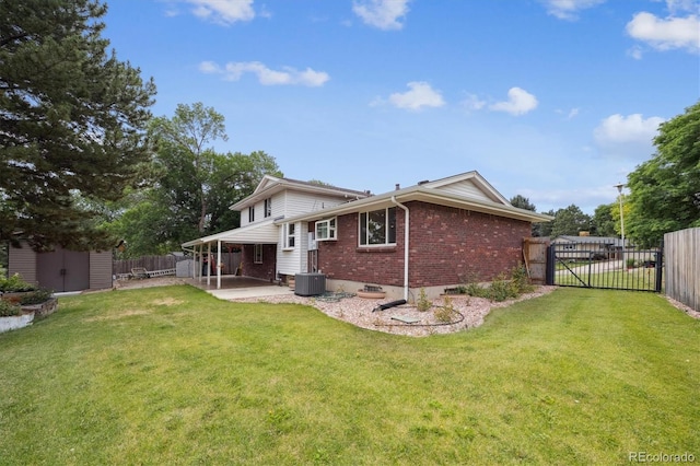 7323 Upham Ct, Arvada, CO 80003 - back of house with brick siding, a patio area, a fenced backyard, a gate, and a storage unit