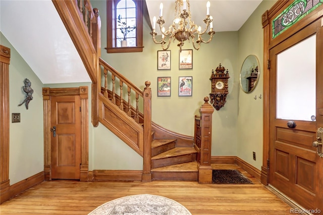 foyer entrance with a chandelier and light hardwood / wood-style flooring