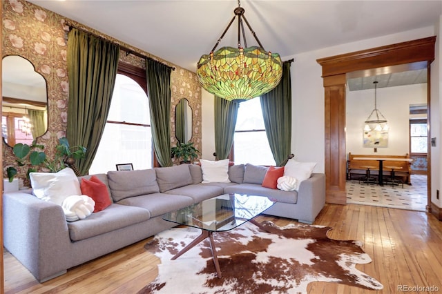 living room featuring hardwood / wood-style flooring, a wealth of natural light, and a chandelier