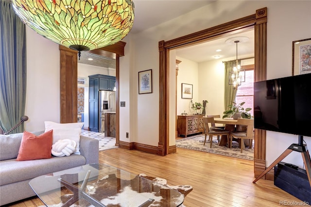 living room featuring wood-type flooring and a notable chandelier