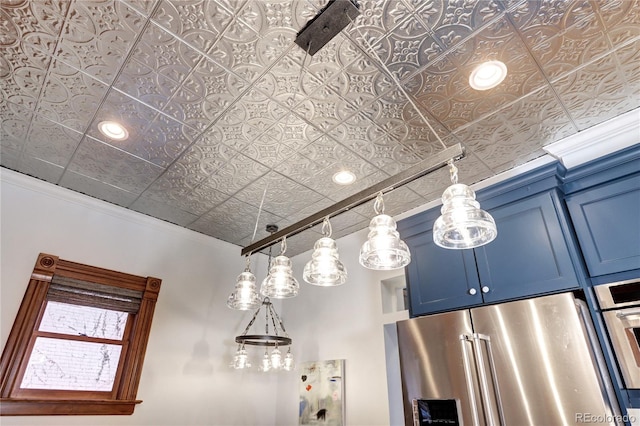 details with high end fridge, blue cabinets, and ornamental molding