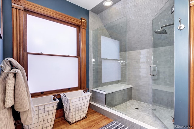 bathroom with hardwood / wood-style floors and walk in shower