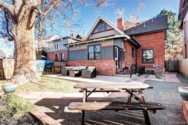 back of property featuring outdoor lounge area and a patio