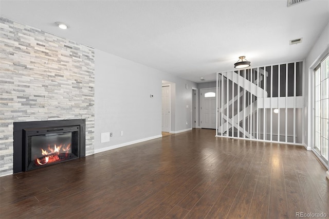 2366 S Troy St, Aurora, CO 80014 - unfurnished living room featuring a fireplace, wood finished floors, and stairs