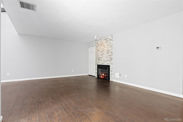 2366 S Troy St, Aurora, CO 80014 - unfurnished living room featuring a large fireplace and dark wood-type flooring