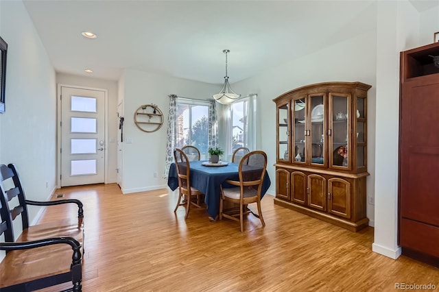 dining space with recessed lighting, baseboards, and light wood finished floors