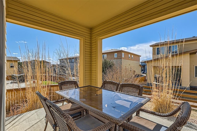 view of patio with outdoor dining area and a balcony