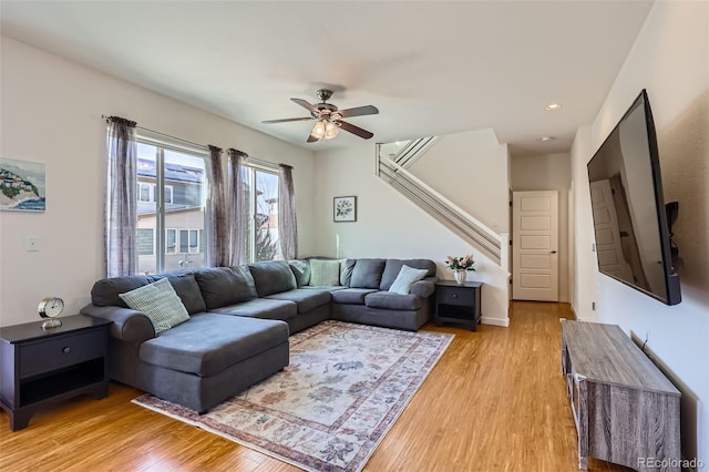 living room featuring recessed lighting, light wood-style flooring, stairs, and ceiling fan