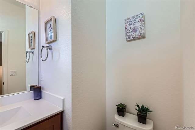 bathroom with toilet and vanity