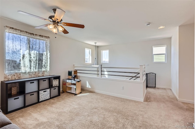 carpeted bedroom featuring a ceiling fan and baseboards