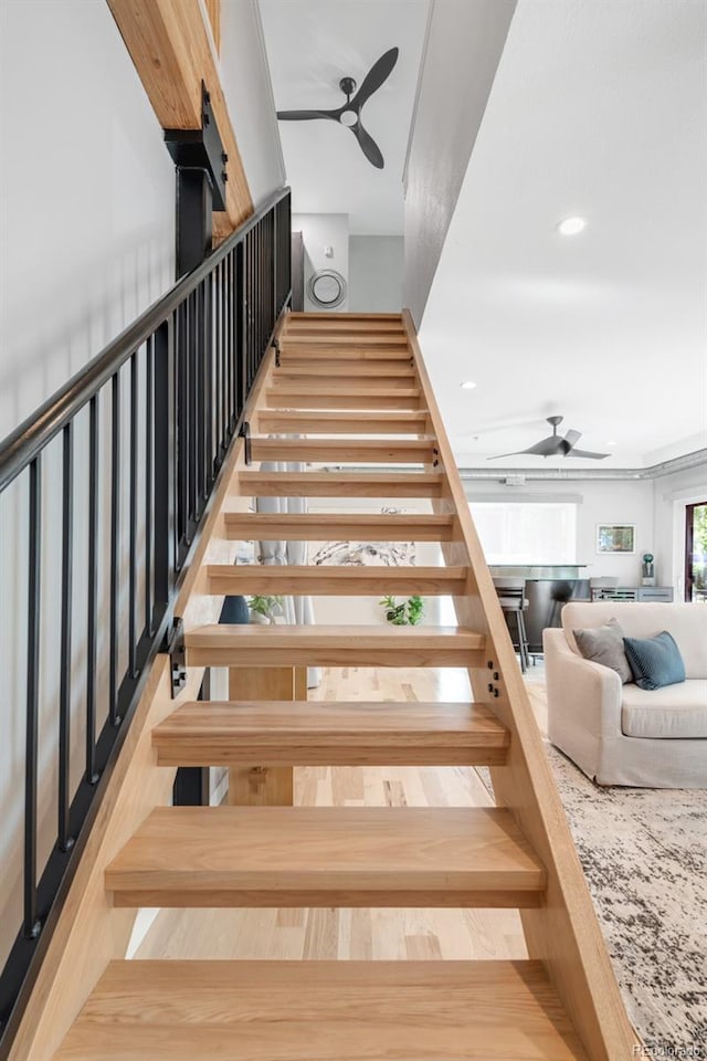 stairs featuring recessed lighting and ceiling fan