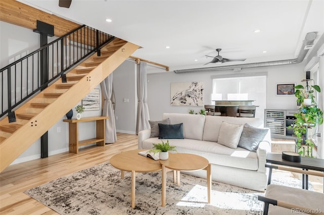 living area featuring ceiling fan, recessed lighting, baseboards, wood finished floors, and stairway