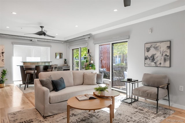 living room with light wood-style floors, ceiling fan, and recessed lighting