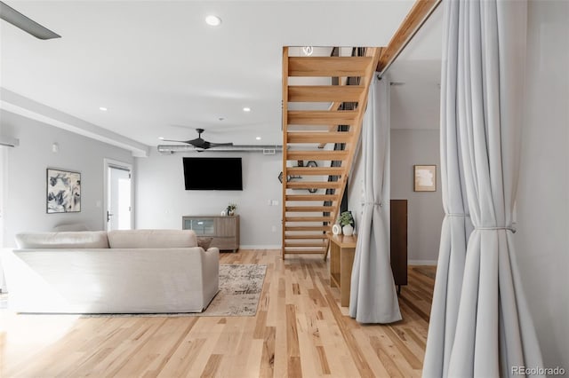 living area with recessed lighting, a ceiling fan, light wood-style flooring, and baseboards