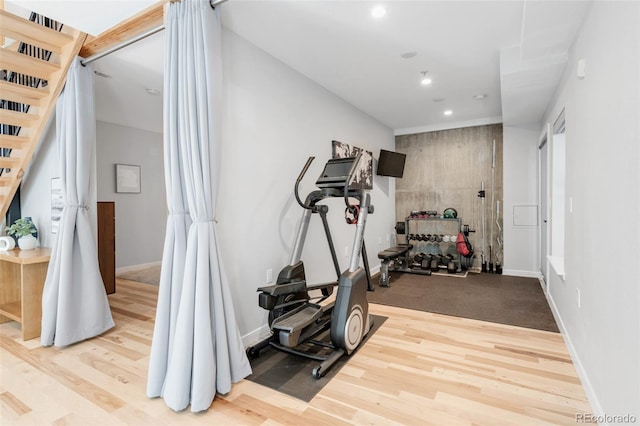 exercise area featuring recessed lighting, baseboards, and wood finished floors