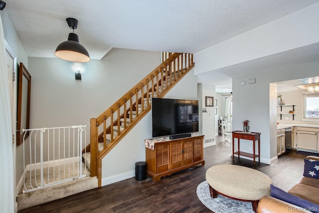 living room featuring dark hardwood / wood-style floors and a textured ceiling