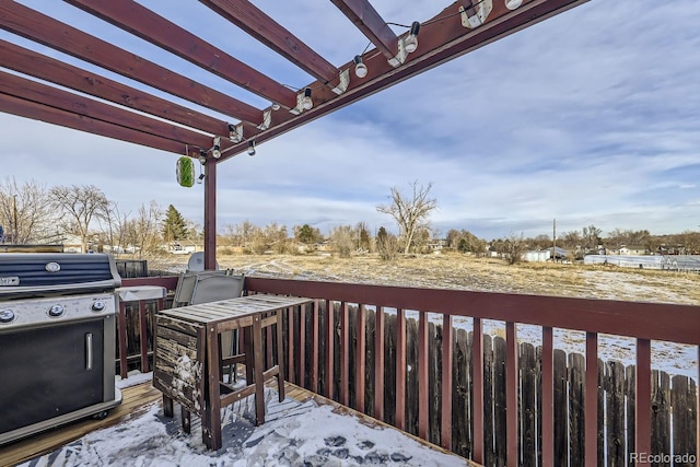 snow covered deck featuring a pergola