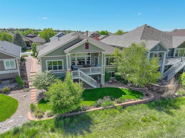 14879 Xenia St, Thornton, CO 80602 - rear view of property with stairway, a shingled roof, and a yard