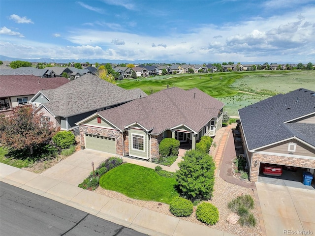 14879 Xenia St, Thornton, CO 80602 - view of front of home with driveway, stone siding, a residential view, and an attached garage