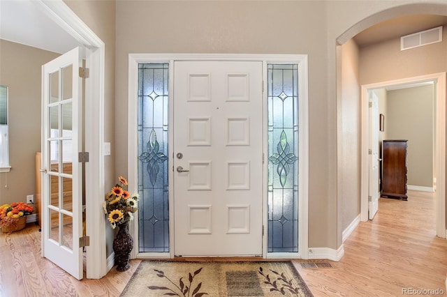 14879 Xenia St, Thornton, CO 80602 - entrance foyer with arched walkways, light wood finished floors, and baseboards