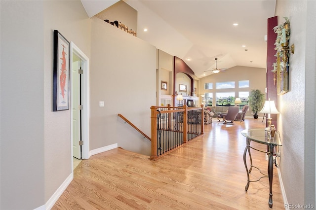 14879 Xenia St, Thornton, CO 80602 - hall featuring an upstairs landing, vaulted ceiling, wood finished floors, recessed lighting, and baseboards