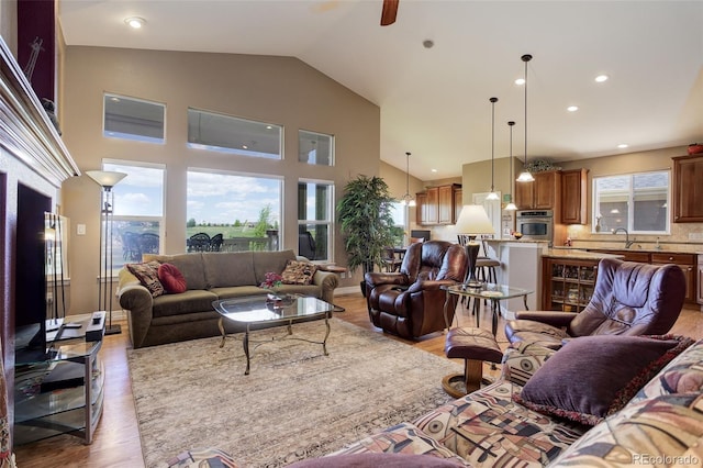 14879 Xenia St, Thornton, CO 80602 - living room featuring healthy amount of natural light, wood finished floors, ceiling fan, high vaulted ceiling, and recessed lighting