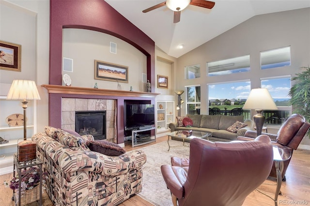 14879 Xenia St, Thornton, CO 80602 - living room with wood finished floors, a fireplace, ceiling fan, and high vaulted ceiling