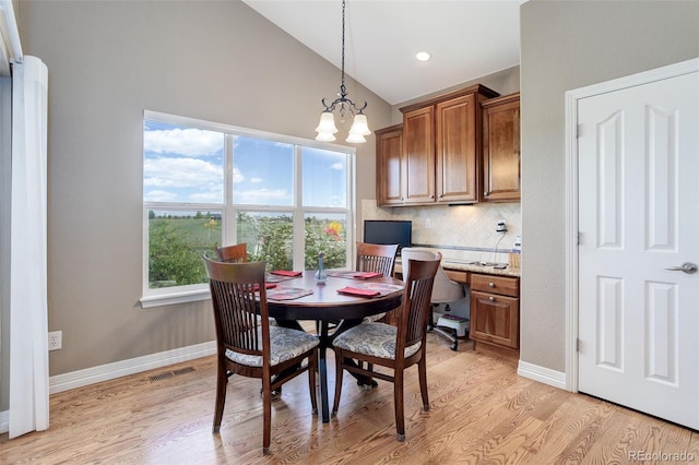 14879 Xenia St, Thornton, CO 80602 - dining area featuring lofted ceiling, light wood-style flooring, a chandelier, baseboards, and recessed lighting